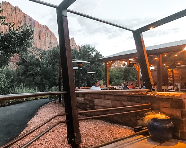 A man sits on the outdoor patio at Zion Canyon Brewing Company outside Zion National Park