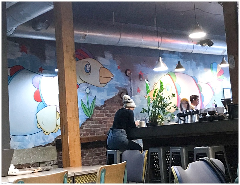 A painted brick wall inside Crema Coffee House in Denver, CO
