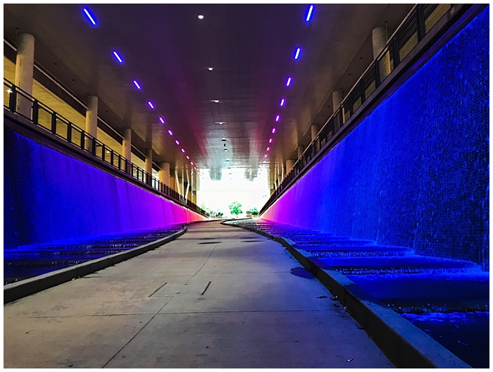 A walkway through a multi-color water fountain under the Westin Convention Center in Pittsburgh, PA