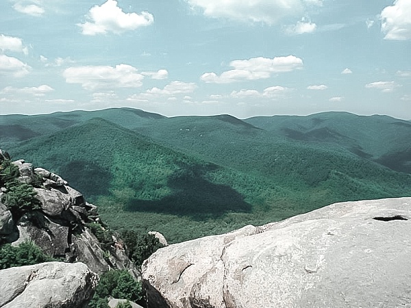 Some rocks along the Old Rag trail in Shenandoah National Park with the mountain range in the distance